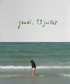 a woman standing in the water on top of a beach next to an advertisement for jeudii 19 juillet