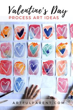 valentine's day process art idea for kids with watercolor hearts on paper and paintbrushes