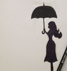 a drawing of a woman holding an umbrella in the rain with a black marker next to it