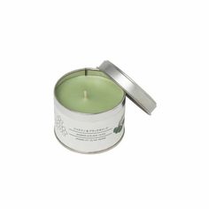 a small tin candle with a metal lid on a white background the candle is open