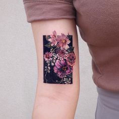 a woman's arm with a flower tattoo on the left side of her arm