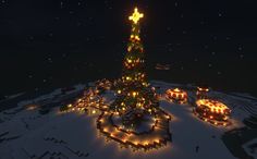 a christmas tree lit up at night in the middle of a snow covered field with lights