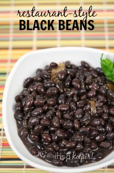 a white bowl filled with black beans on top of a table