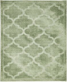 a green rug with an intricate design on the front and back side, in shades of light green