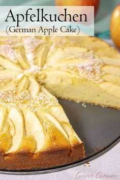 a close up of a cake on a plate with an apple in the back ground