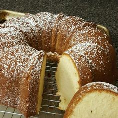 a cake that is sitting on a cooling rack with powdered sugar sprinkled on it