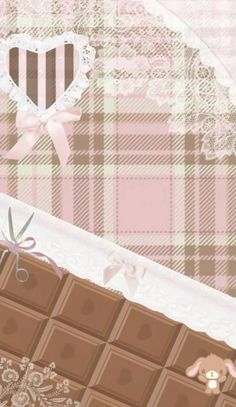 the chocolate bar is decorated with pink ribbon and bow on it's side, next to a heart - shaped piece of cake