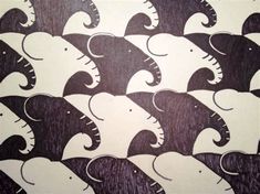 an image of elephants in the middle of a pattern on a piece of paper that looks like wood