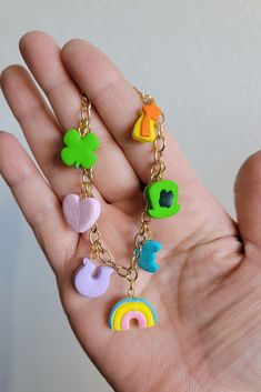 a hand holding several different colored charms on it