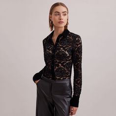 The SALINGER is a sheer black net shirt embroidered with lace floral patterns outlined in velvet. This luxurious piece features a point collar, center button placket and French cuffs that allows for cufflinks, all in black velvet. The SALINGER is a stunning silhouette that will elevate any ensemble. Body: 92% Polyamide, 8% Elastane; Collar, Cuff & Button Tab: 90% Polyester, 10% Elastane; Under Collar & Under Button Tab: 100% Polyester Follow care instructions on garment Luxury Blouse With Lace Trim, Luxury Long Sleeve Tops With Lace Trim, Black Lace Top For Formal Occasions, Classic Fitted Blouse With Sheer Sleeves, Classic Sheer Evening Tops, Classic Blouse With Sheer Sleeves And Fitted Design, Luxury Sheer Sleeves Party Blouse, Luxury Fitted Tops With Sheer Sleeves, Luxury Sheer Tops For Party