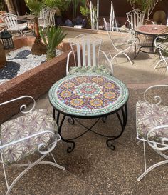 an outdoor table and chairs are sitting on the ground