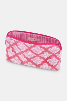 a pink and white cosmetic bag with hearts on the front, zippered closures