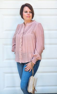 This super detailed Button Up Split Neck Top in Mauve includes long sleeves with smocked elasticized cuffs, split neckline,functional buttons, geometric detail, sheer, but not lined. SO CUTE. Take on all occasions wearing this beautiful top. ABOUT THIS ITEM: Made in Vietnam. Fabric is 62% Rayon / 38% Polyester. Hand wash in cold water. Wash inside out. Hang or line dry. The Model is 5'6, and wearing a large, runs a little small. Feminine Smocked Top With Blouson Long Sleeves, Chic Long Sleeve Smocked Blouse, Chic Smock Long Sleeve Blouse, Chic Long Sleeve Smock Blouse, Bohemian Tops With Button Cuffs And Long Sleeves, Chic Long Sleeve Blouse With Smocked Bodice, Long Sleeve Smocked Top For Work, Feminine Long Sleeve Smock Blouse, Bohemian Long Sleeve Smocked Top With Cuffs