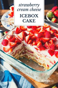 strawberry cream cheese icebox cake in a glass dish on a table with strawberries