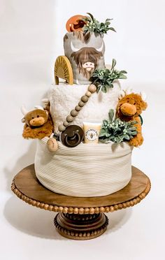 a cake decorated with stuffed animals and plants