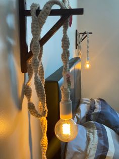 a rope light hanging from the side of a bed