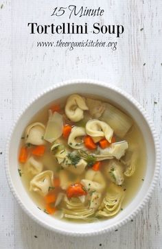 a white bowl filled with tortellini soup