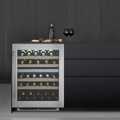 a wine cooler with several bottles and glasses on it