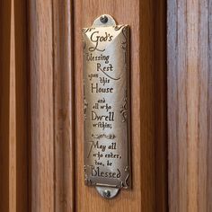 a metal plaque on the side of a wooden door saying god's blessing to rest in his house