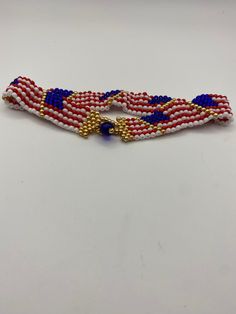 This is a unique idea. I love making these.  I made this wavy American flag anklet using myuki 8/0 seed beads. Myuki are known for being top quality glass beads made in Japan.  This anklet measures right at 10 inches long and about 3/4 inches wide and bares 7 American flags that have a wave in them.  The anklet is secured by a 6mm cobalt blue bead and gold toned seed beads as a clasp. This is hand sewn and I guarantee it will not break. Show your American pride with this unique anklet.  I also have matching bracelets right here on my Etsy page. Diy American Flag, Flag Beads, Beaded Anklet, American Flags, Beaded Anklets, American Pride, Anklet Jewelry, Body Jewellery, Matching Bracelets