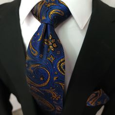 This set is perfect for business meetings, weddings, and other formal events. The silk material is soft to the touch and adds a touch of luxury to any outfit. The navy blue and gold color combination is timeless and pairs well with a variety of shirt and suit colors. 100% Silk Handmade Package Includes: Tie, Pocket Square & Cufflinks. Length: 59" Width: 3.34" Warm iron if needed Suit Colors, Formal Ideas, Jw Family, Gold Color Combination, Gold Paisley, Navy Blue And Gold, Necktie Set, Gold Tie, Navy Blue Suit