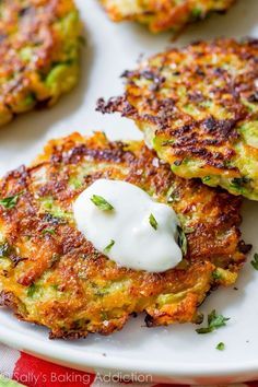 some food is on a white plate and ready to be eaten with sour cream in the middle