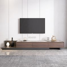 a flat screen tv sitting on top of a wooden entertainment center in a living room