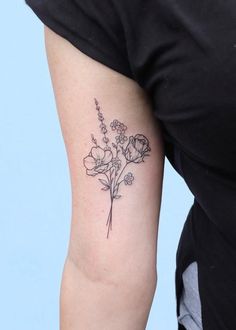 a woman with a flower tattoo on her arm