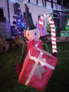 an inflatable christmas present being carried by a man