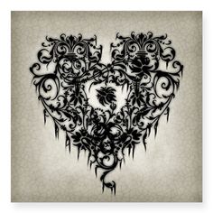 an ornate heart with vines and flowers on it's side, in black ink