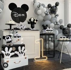 a mickey mouse themed birthday party with balloons