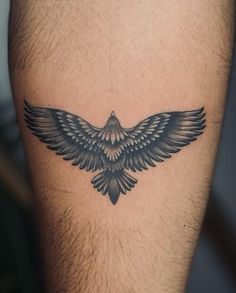 a black bird tattoo on the right thigh and lower leg, with wings spread out