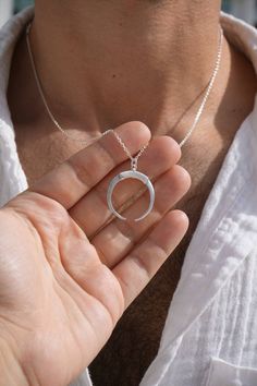 Embrace the magic of the moon with our Moon Ring Holder Necklace, a stunning blend of celestial beauty and practical design. This handcrafted piece not only adds a touch of enchantment to your jewelry collection but also keeps your precious rings safe and close. Premium Materials: Expertly crafted from high-quality 925 sterling silver over 14k gold plated or rhodium , ensuring durability and a radiant shine. Secure Moon Design: The moon-shaped pendant features a secure holder mechanism, perfect for keeping your rings safe and accessible. Celestial Charm: Inspired by the moon's serene beauty, this necklace adds a touch of cosmic elegance to any outfit. Thoughtful Gift: Ideal for weddings, anniversaries, birthdays, or any special occasion for the moon lover in your life. Ring Holder Pendant, Ring Halter, Crescent Ring, Ring Holder Necklace, Precious Rings, Moon Ring, Celestial Jewelry, Practical Design, Moon Design