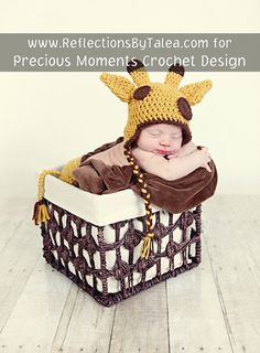 a baby wearing a giraffe hat laying in a basket with the words reflections by talea com for precious moments crochet design