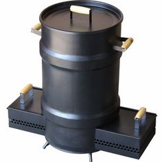 a large black barrel sitting on top of a metal stand