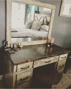 a bedroom with a bed, dresser and mirror