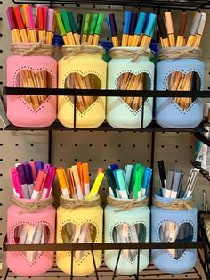 the shelves are filled with different colored pens and pencils in heart - shaped containers