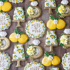 decorated cookies with lemons and flowers are arranged on a wooden table, along with the words miss me mrs