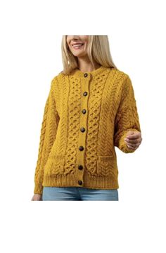 a woman wearing a yellow cardigan sweater with buttons on the front and side, smiling