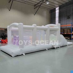 an inflatable structure is set up on the floor for people to use it