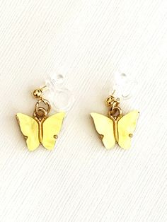 Cute yellow butterfly clip on earrings for children are available here! These small butterfly earrings for kids are comfortable to wear. The .75 inch butterflies dangle from clear clips with gold balls. They would make a great gift idea for tweens! These clip on earrings are designed and handmade by me, Sharon, of Blonde Peach Jewelry. They will arrive in an attractive organza bag that is great for storage and gift giving. Feel free to contact me with any questions you may have regarding the ear Earrings For Kids, Peach Jewelry, Butterfly Kids, Small Butterfly, Butterfly Clips, Yellow Butterfly, Kids Earrings, Butterfly Charm, Butterfly Earrings