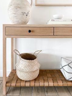 Styled view of White Oak Leather Strap Console Table with Sculptural Nest Basket against a white wall. - Saffron and Poe White Oak Console, Living Tv, Oak Console Table, Console Table With Drawers, Leather Counter Stools, Neutral Interiors, Wood Console Table, Wood Console, Open Shelf