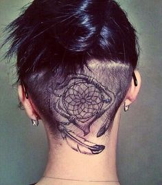 the back of a woman's head with a tattoo on her neck and behind it is an image of a dream catcher