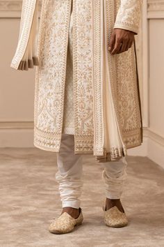 Ivory, taupe sherwani embroidered all-over in aari and zardozi threadwork and highlighted with Swarovski crystals. Paired with an ivory chanderi-jacquard kurta and churidar. Comes with embroidered kamarbandh and stole.
Components:5
Pattern:Embroidered
Type of Work:Aari, Zardozi
Neckline:Mandarin
Sleeve Length:Three Quarter
Fabric:Sherwani: Raw Silk, Kurta: Chanderi Jacquard, Churidar: Poplin Lycra, Kamarbandh: Raw Silk, Stole: Katan Silk
Color:White
Other Details:
Embroidered kamarbandh and stol Raw Silk Kurta, Embroidered Sherwani, Silk Kurta, Tarun Tahiliani, Nehru Jackets, Katan Silk, Churidar, Formal Shirts, Embroidered Silk