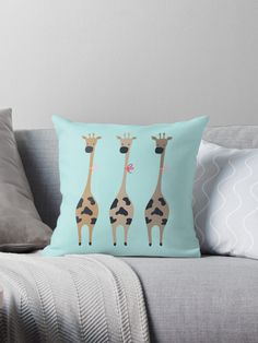 three giraffes standing next to each other on a blue background throw pillow