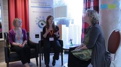 three women sitting in chairs talking to each other