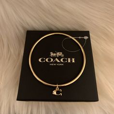 Coach Bangle Bracelet With “C” Charm Nwot Includes Coach Dust Bag & Unbranded Box. Coach Bangle Bracelet (One) With Charm. Charm In Gold Over Brass! This Is Simply Adorable For Gift Giving To Anyone. Authentic! Perfect Present Or Treat Yourself! Please See Closeup For Great Charm Detail! Perfect For The Coach Collector! Brand New With Out Tags- Plastic Tag Holder Still Attached. Nwot Item Never Used. Card Is For Pics Only. Review Pics For Part Of Description. Bangle Part Of A Triple Set, Only On Coach Bracelets Bangles, Coach Charms, Coach Bangle, Boxing Coach, Tag Holder, Gift Giving, Bangle Bracelet, Bangle Bracelets, Original Box