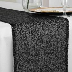 a black table runner on top of a white table