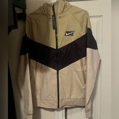 Brand New With Tag, Never Worn. Excellent Condition. Came Too Small On My Husband. Nike Casual Cream Outerwear, Casual Cream Nike Outerwear, Nike Casual Brown Outerwear, Casual Nike Brown Outerwear, Casual Brown Nike Outerwear, Nike Brown Outerwear For Winter, Vintage Nike Jacket, Nike Windbreaker Jacket, Vintage Nike Windbreaker