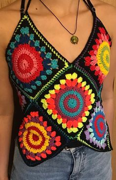 a woman wearing a crocheted top with multicolored circles on it